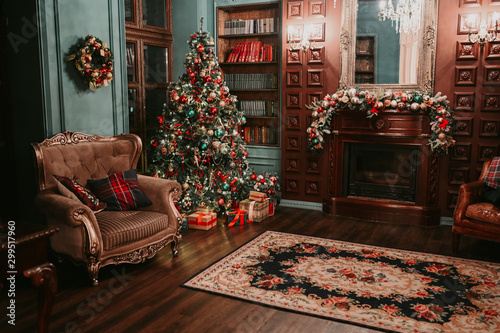 Classic living room and library New Year interior. Magic glowing Christmas tree, carpet, decorated fireplace and mirror, cozy armchair and gift present boxes in dark at night. Festive holiday evening