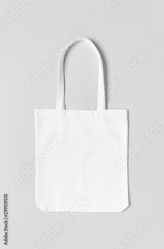 White tote bag mockup on a grey background.