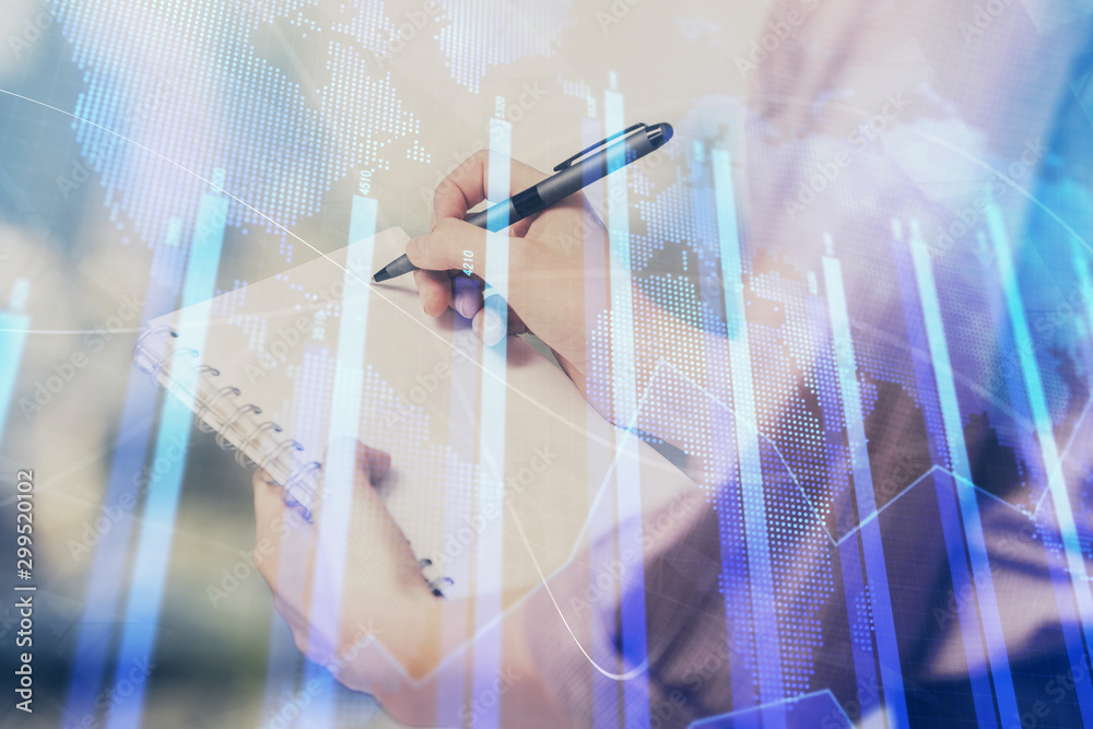 Multi exposure of hands making notes with forex chart huds. Stock market concept.