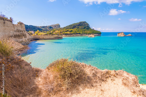 Colorful spring view of famous Channel Of Love (Canal d'Amour) beach. Bright morning seascape of Ionian Sea. Amazing outdoor scene of Corfu Island, Greece, Europe. Beauty of nature concept background