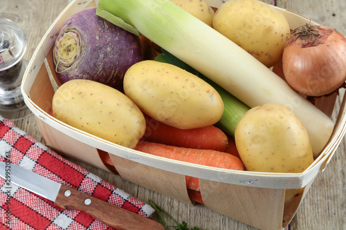 raw vegetables for pot on fire on a wooden table photo