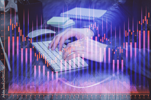 Stock graph with businessman typing on computer in office on background. Concept of analysis. Double exposure. © peshkova