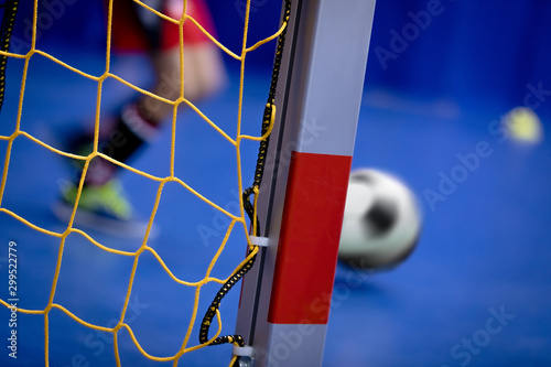 Indoor Soccer Background. Futsal Junior Player on Indoor Training. Soccer Goal with Yellow Net. Soccer Winter Class at School Indoor Futsal Court. Young Player in an Indoor Play-field photo