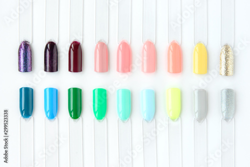 Nail polish samples in different bright colors. Colorful nail lacquer manicure swatches. Top view of nail art samples palette. Free copy space.
