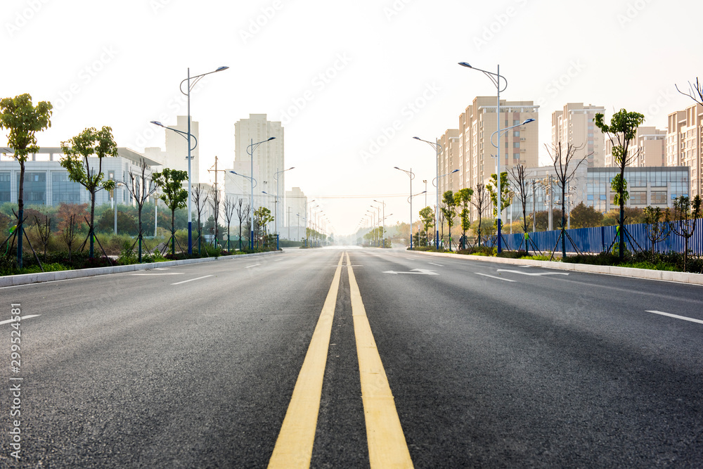 Asphalt road and beautiful blue sky in the background of sunrise