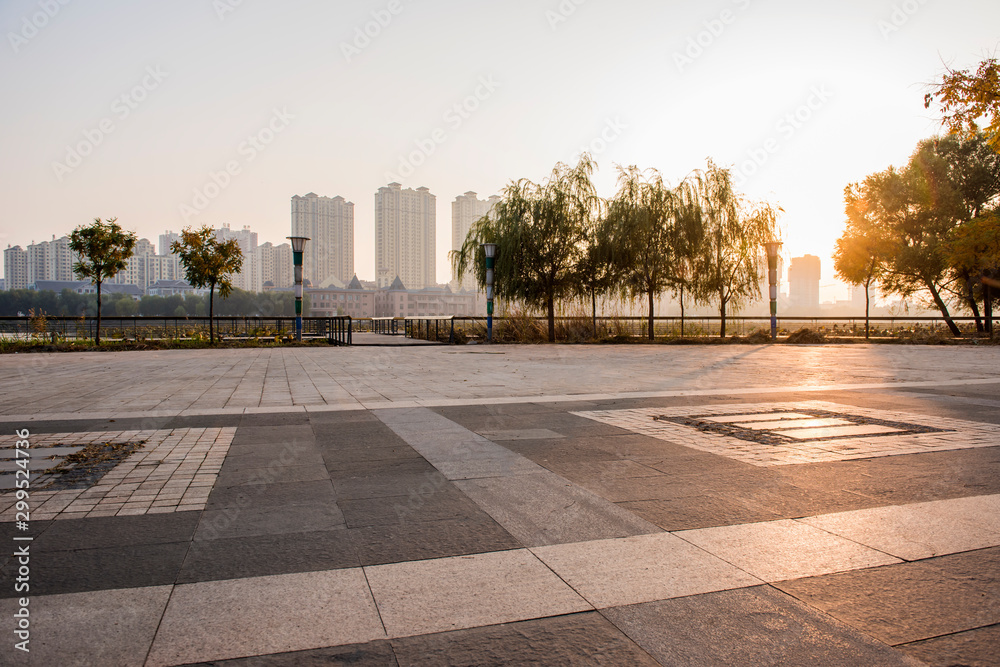 Empty city square marble pavement and beautiful blue sky in the background at sunrise