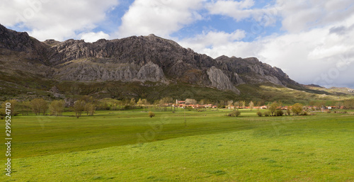 Nice Mountain Village (Cubillas de Arbas) in valley with green spring meadows, Leon province, Spain  photo