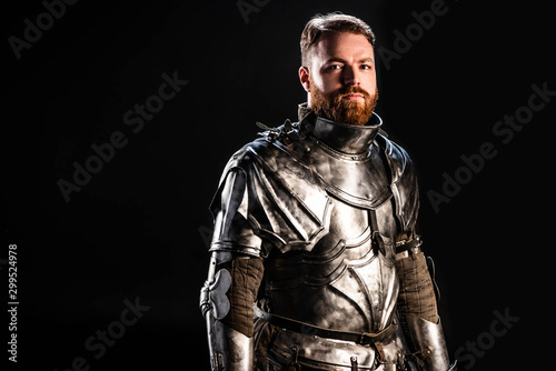 handsome knight in armor looking at camera isolated on black © LIGHTFIELD STUDIOS