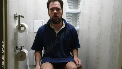 man sitting on the toilet, bowel problem photo