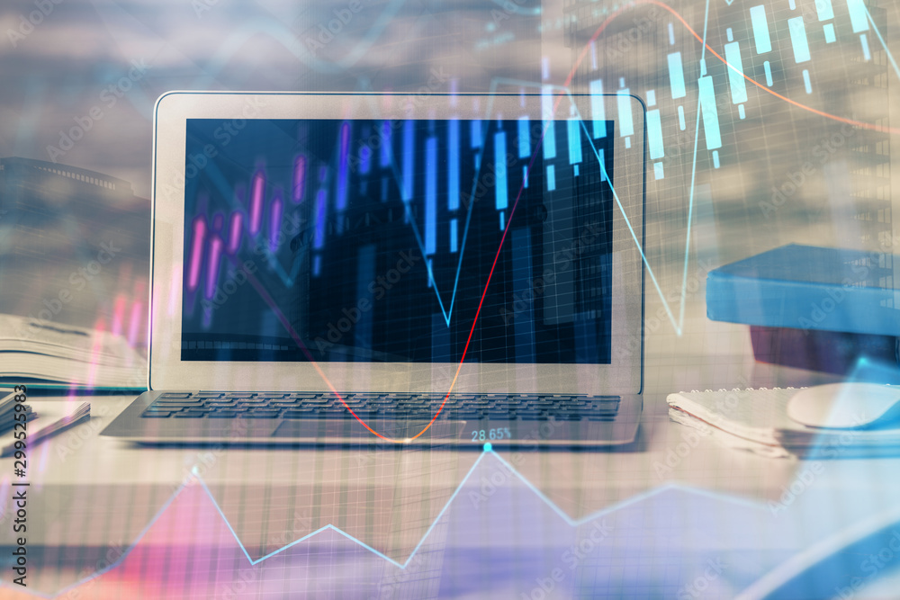 Financial chart drawing and table with computer on background. Double exposure. Concept of international markets. Financial chart drawing and table with computer on background. Double exposure. Concept of international markets.