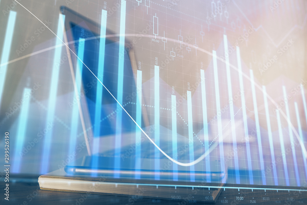 Stock market chart hologram drawn on personal computer background. Multi exposure. Concept of investment. Stock market chart hologram drawn on personal computer background. Multi exposure. Concept of investment.