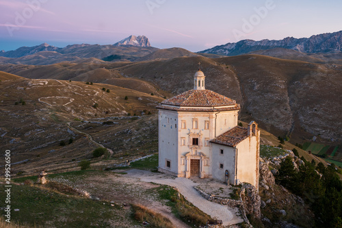 Beautiful chapel Chiesa di Santa Maria della Pietà at dawn before sunrise with barren landscape and mountain of Corno Grande in background, Rocca Calascio, Abruzzo, Italy