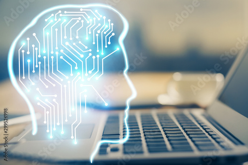 Double exposure of table with computer and brain hologram. Data innovation concept.
