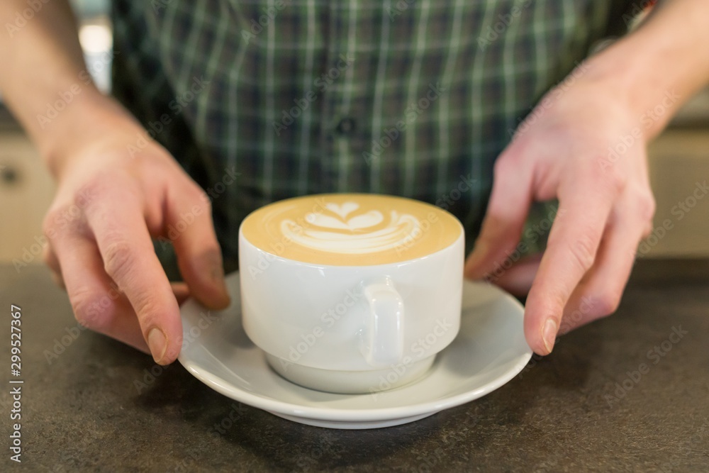 Cup of coffee art with the hands of male barista Cup of coffee art with the hands of male barista