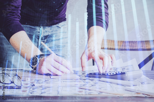 Multi exposure of man standing and planing investment with stock market forex chart.