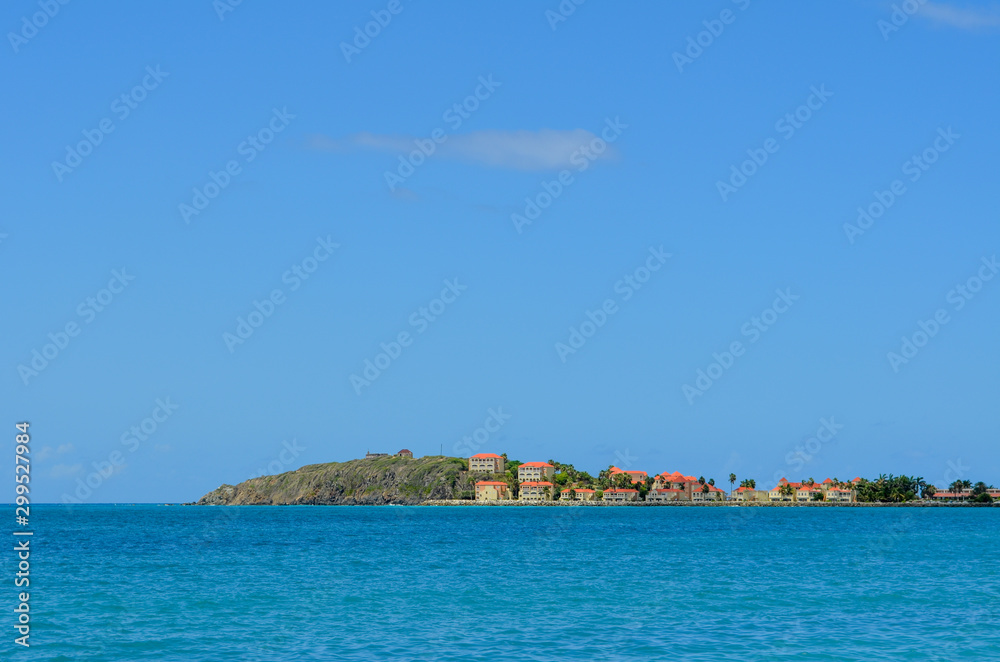 Distant view of Caribbean village with colorful roofs
