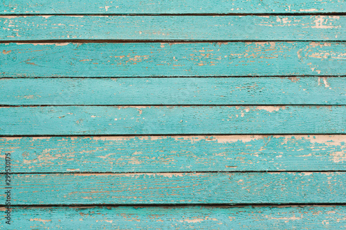 wooden background, a fragment of the wall of an old wooden house painted in turquoise