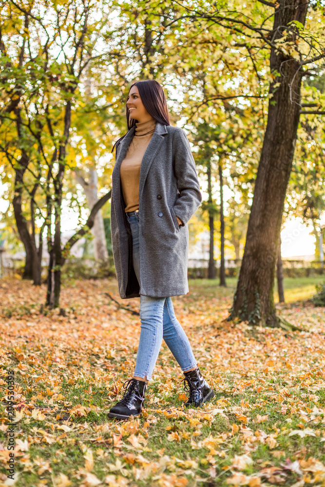 Beautiful woman walking in the park and enjoys in autumn. Beautiful woman walking in the park and enjoys in autumn.