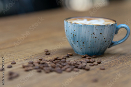 blue coffee mug and coffee beans