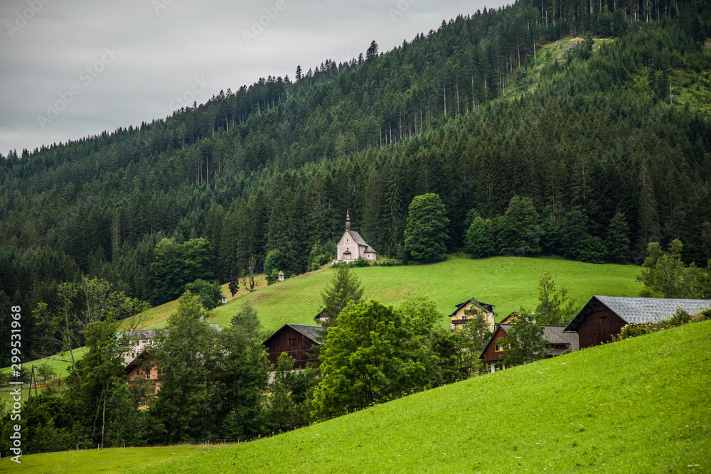 Austria - July, 2019: Country road in the alps village in Austria