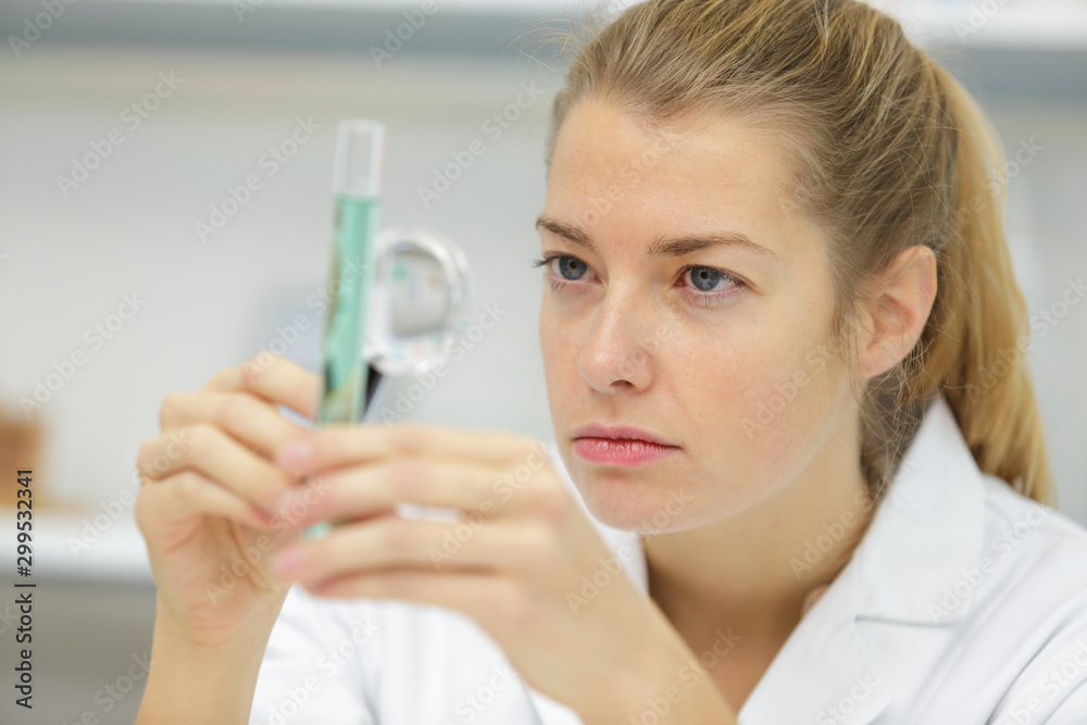 woman holding a magnifier laboratory science woman holding a magnifier laboratory science