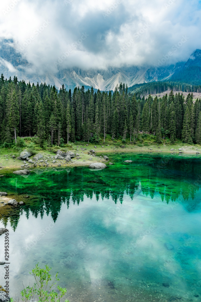 Vertical view of Lake Carezza with reflections