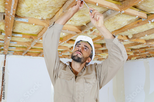 man builder working on the ceiling