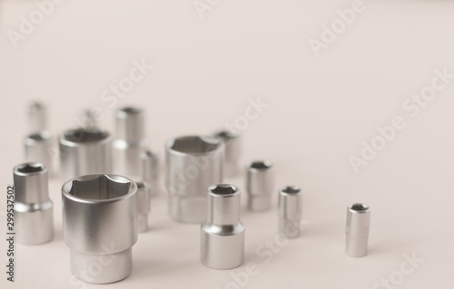Bits set for ratchet wrench on the beige background. Tools for home workers, factory workers, auto mechanics and other works.
