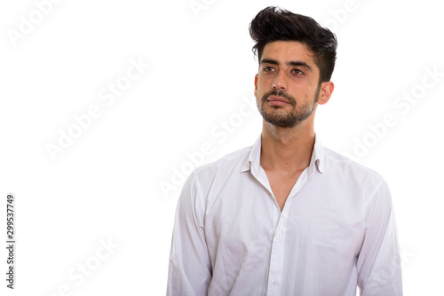 Portrait of young handsome bearded Persian businessman