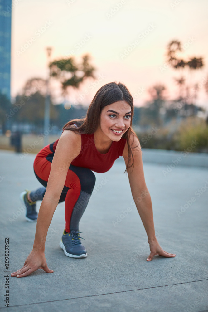 Young woman doing exercise in an urban park. Young woman doing exercise in an urban park.