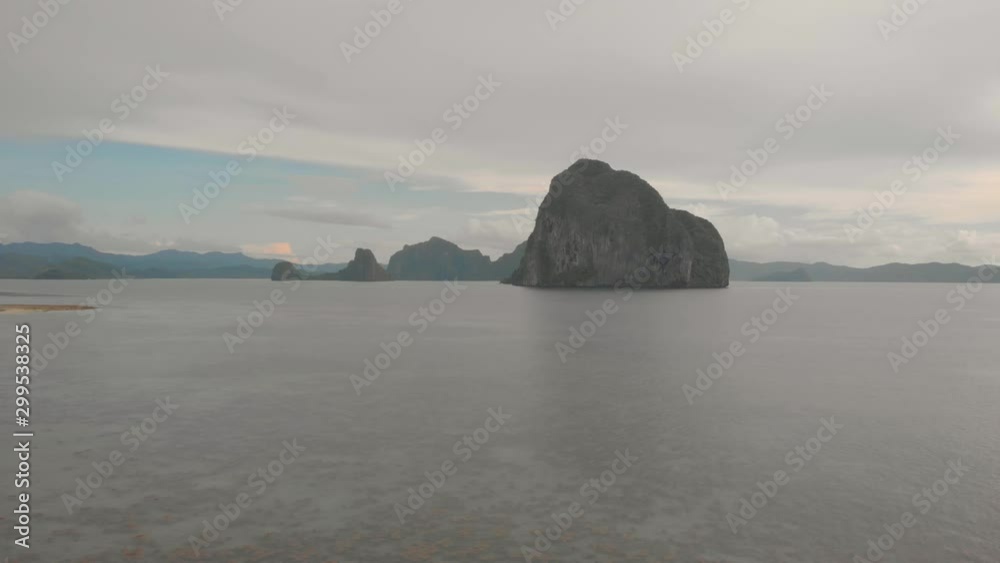 Pinagbuyutan Island in El Nido, drone shot from Las Cabanas Beach at sunset in Palawan, Philippines Pinagbuyutan Island in El Nido, drone shot from Las Cabanas Beach at sunset in Palawan, Philippines