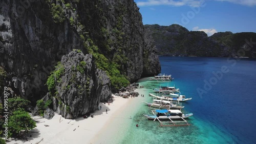 Incredible white beach and black limestone cliffs at Talisay Beach in El Nido, aerial shot in Palawan, Philippines photo