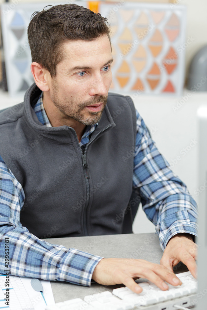 warehouse worker or supervisor with pc in office warehouse worker or supervisor with pc in office