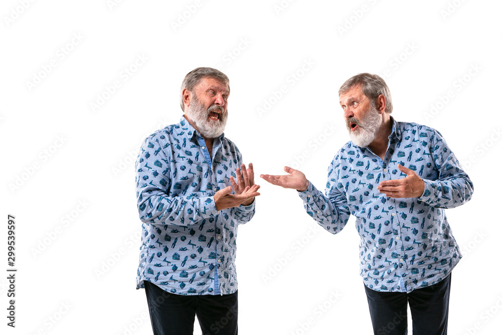 Senior man arguing with himself on white studio background. Concept of human emotions, expression, mental issues, internal conflict, split personality. Half-length portrait. Negative space. Pleased. Senior man arguing with himself on white studio background. Concept of human emotions, expression, mental issues, internal conflict, split personality. Half-length portrait. Negative space. Pleased.