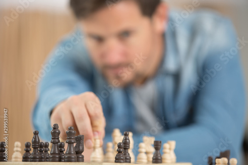 focused picture of man moving chess pawn