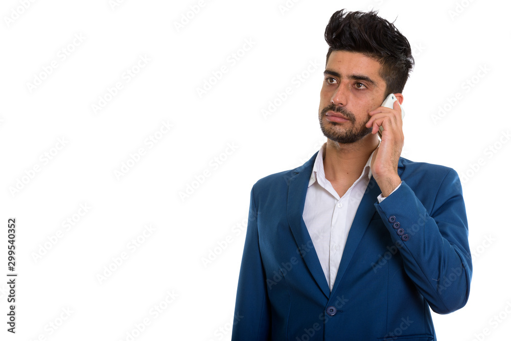 Young handsome bearded Persian businessman talking on the phone Young handsome bearded Persian businessman talking on the phone