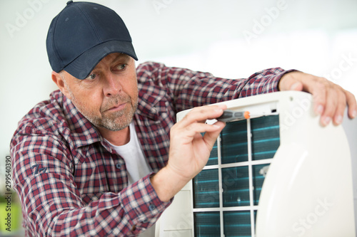 man trying to repair the air conditioning