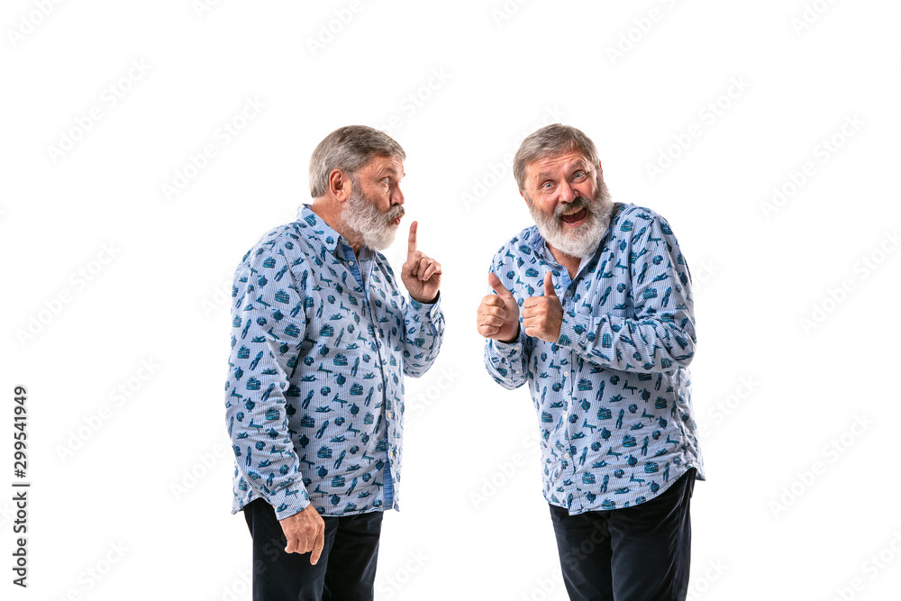 Senior man arguing with himself on white studio background. Concept of human emotions, expression, mental issues, internal conflict, split personality. Half-length portrait. Negative space. Secret. Senior man arguing with himself on white studio background. Concept of human emotions, expression, mental issues, internal conflict, split personality. Half-length portrait. Negative space. Secret.