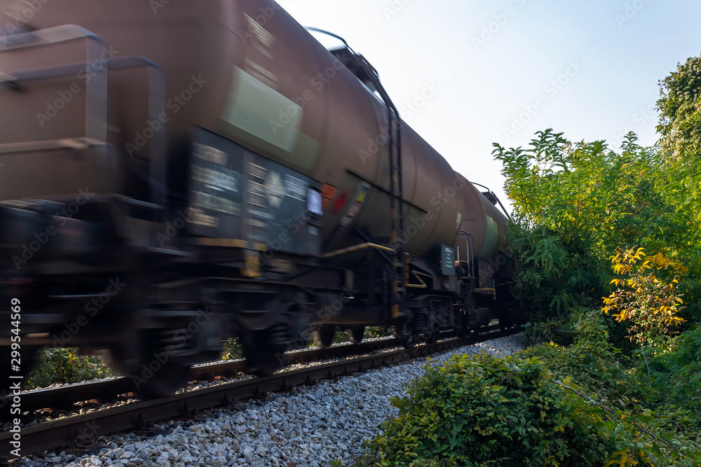 Obraz premium Freight train - wagon tanks, passing the railroad. Motion blur