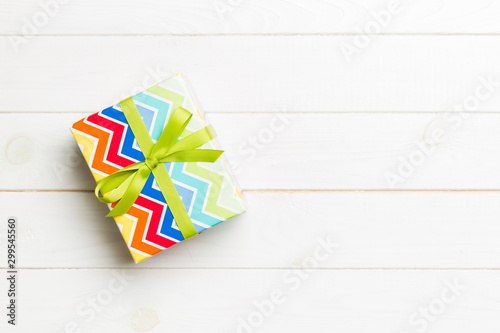 Top view of christmas or other holiday handmade present box package, flat lay white wooden background with copy space. new year gift box