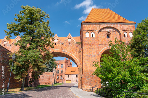 Part of the old city wall of Torun with a defence tower and Teutonic castle, Poland.