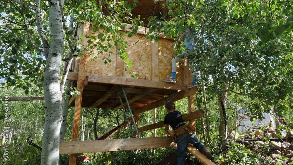Kids working together to build a tree house Kids working together to build a tree house