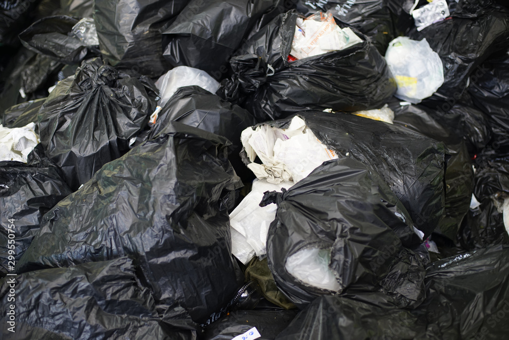 Black garbage bags in the hospital, pile of plastic waste.