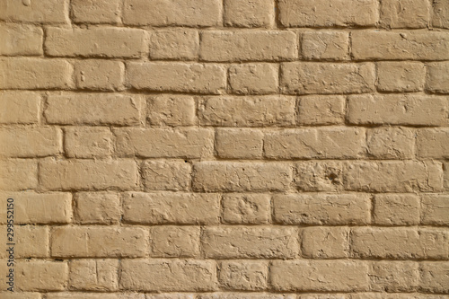 Texture of a brick wall painted in beige as a background