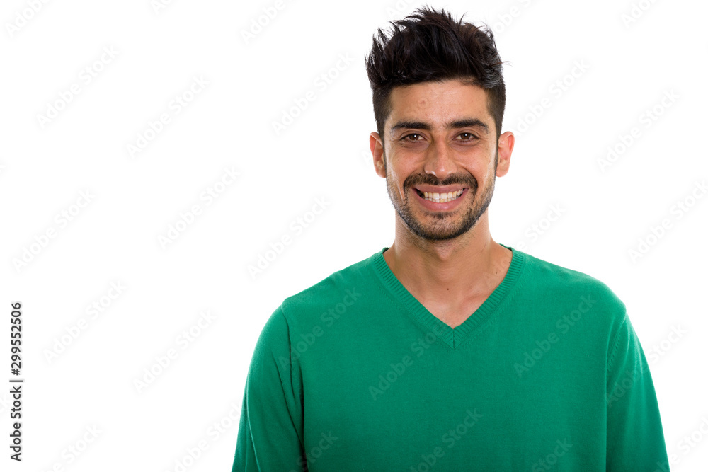 Studio shot of young happy Persian man smiling Studio shot of young happy Persian man smiling