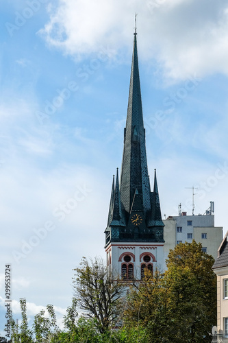 Church with slate roof in front of blue sky