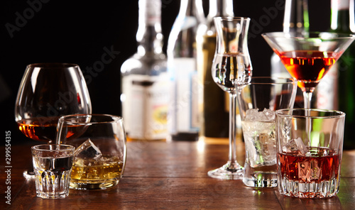 Array of alcoholic beverages in glasses at a bar