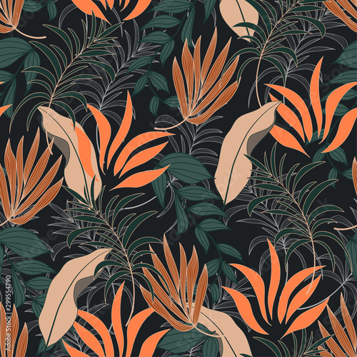 Abstract seamless tropical pattern with bright green and orange leaves and plants on dark background.  Vector design. Jungle print. Floral background.  Seamless exotic pattern with tropical plants.