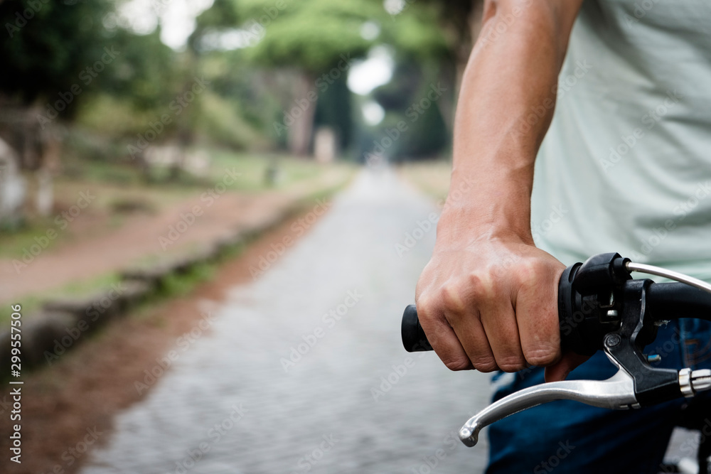 man cycling by the Via Appia Antica in Rome, Italy