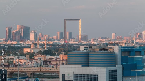 Wallpaper Mural Modern skyscrapers and mosque at sunset with bright lights day to night transition aerial timelapse in Business Bay, Dubai, United Arab Emirates Torontodigital.ca